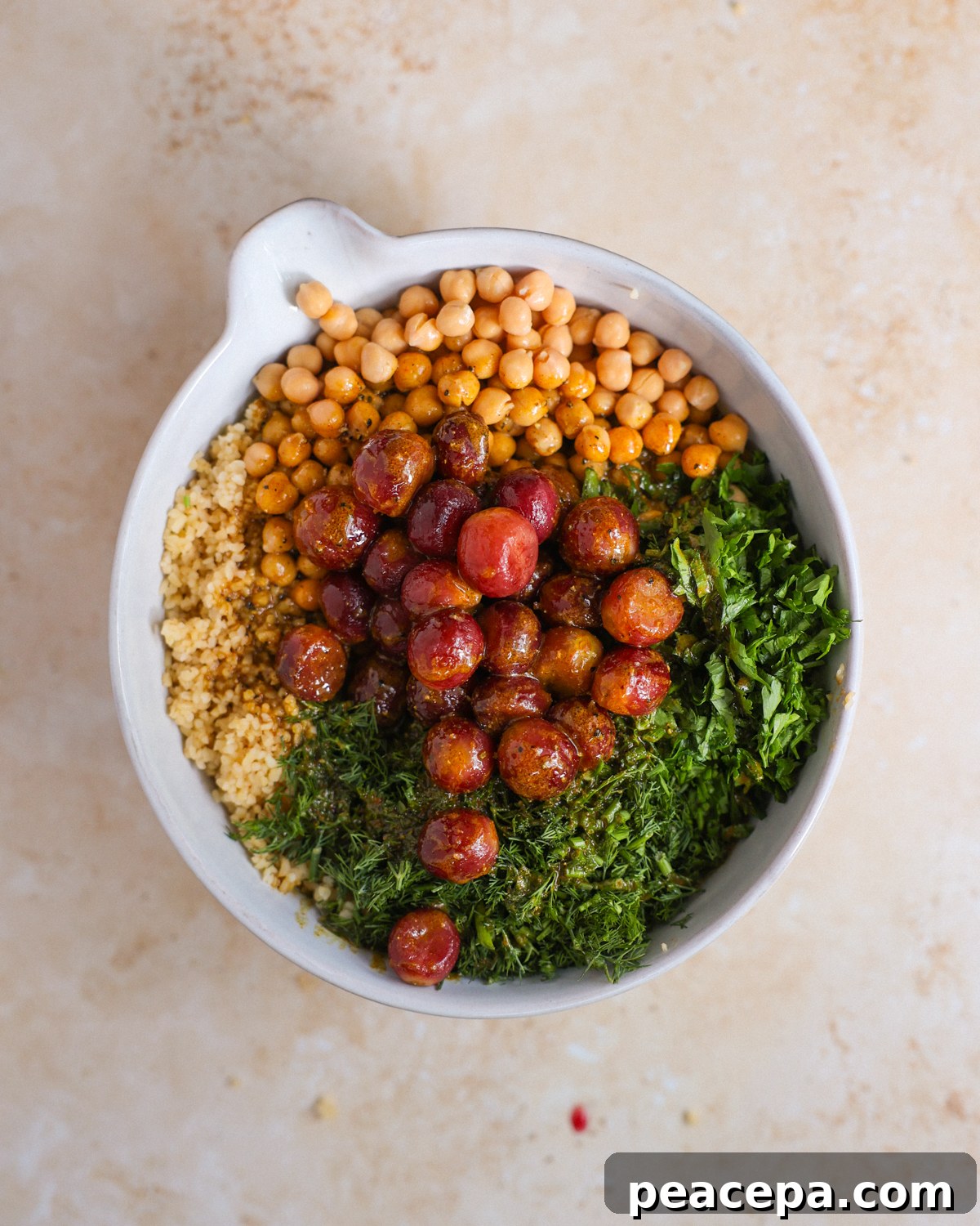 overhead of bulgur salad ingredients in mixing bowl