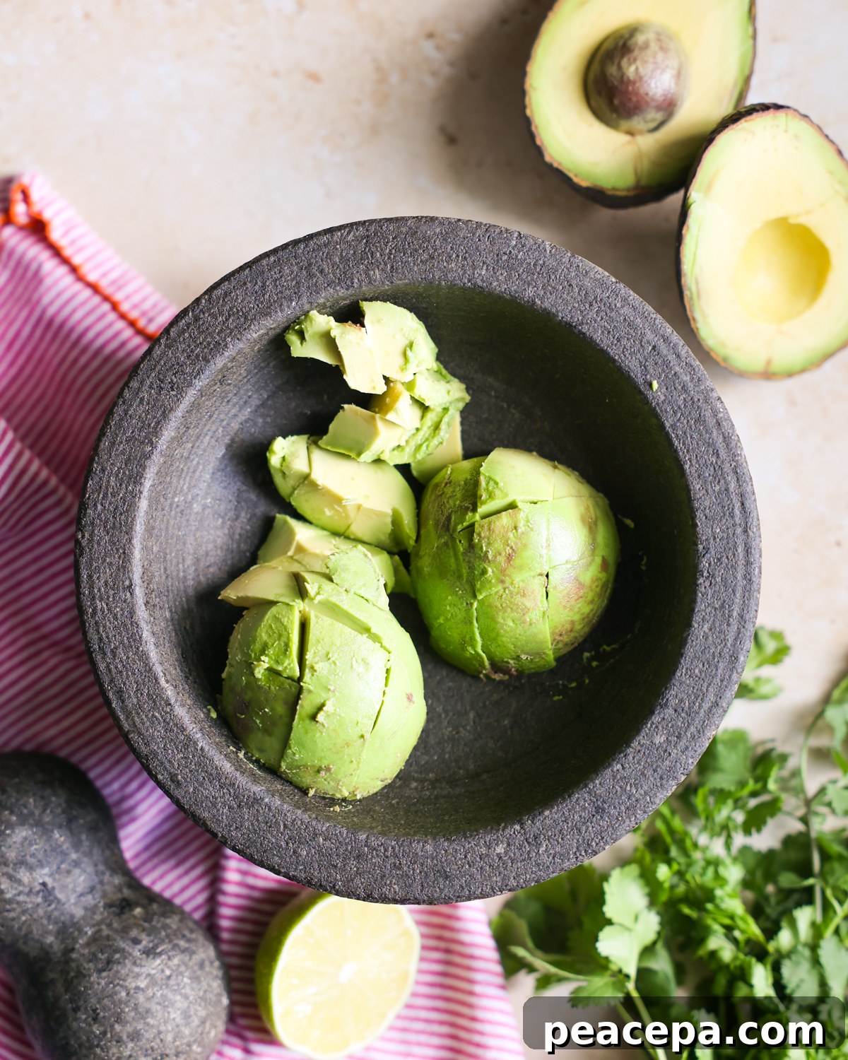 Creamy Homemade Guacamole Recipe for Parties and Dips 4 Avocado in a mortar bowl.