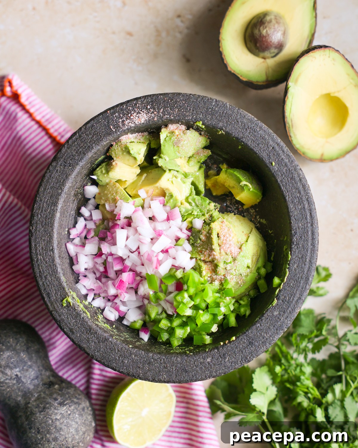 Creamy Homemade Guacamole Recipe for Parties and Dips 5 Easy guacamole ingredients in a bowl.