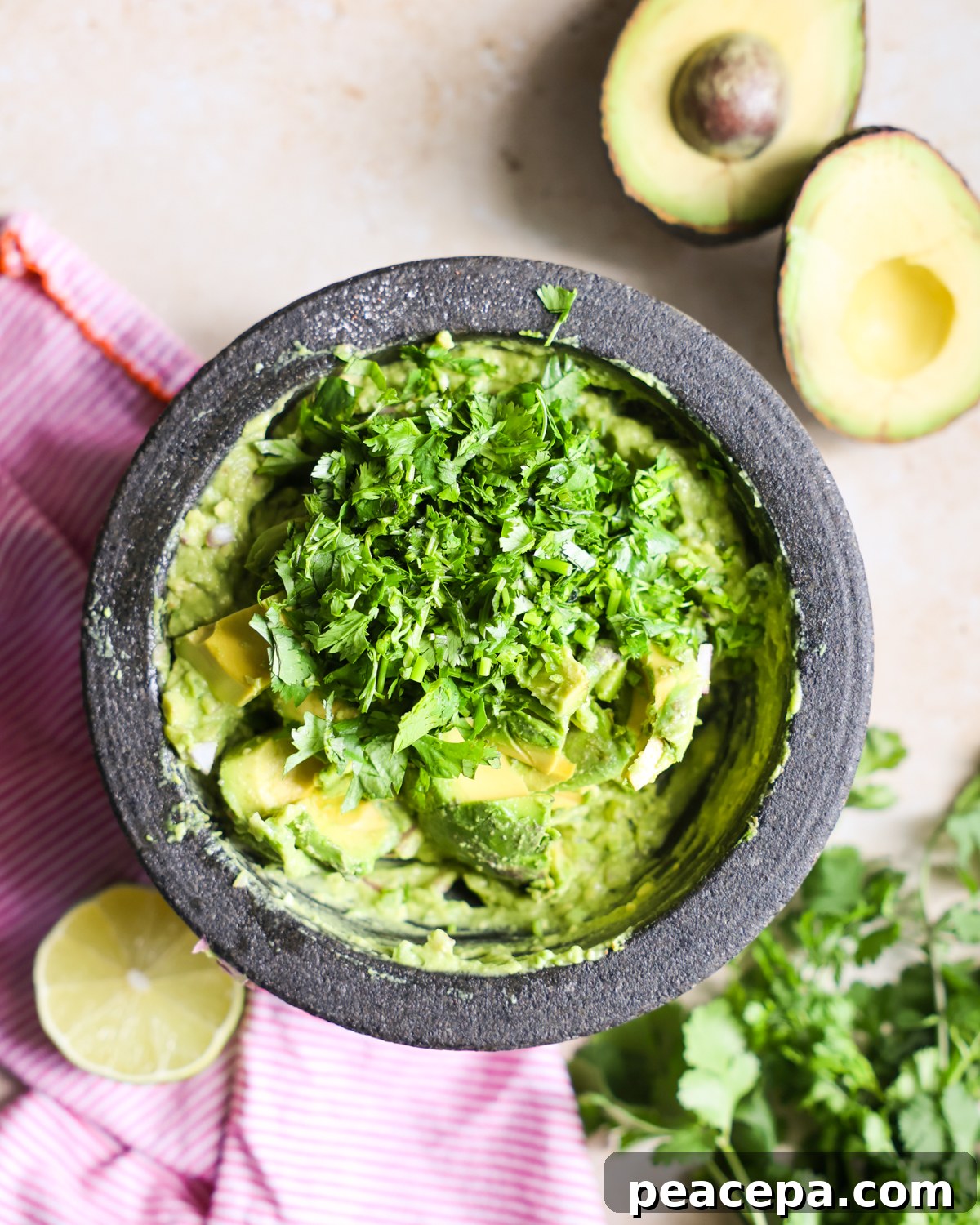 Creamy Homemade Guacamole Recipe for Parties and Dips 7 Cilantro added to guacamole.